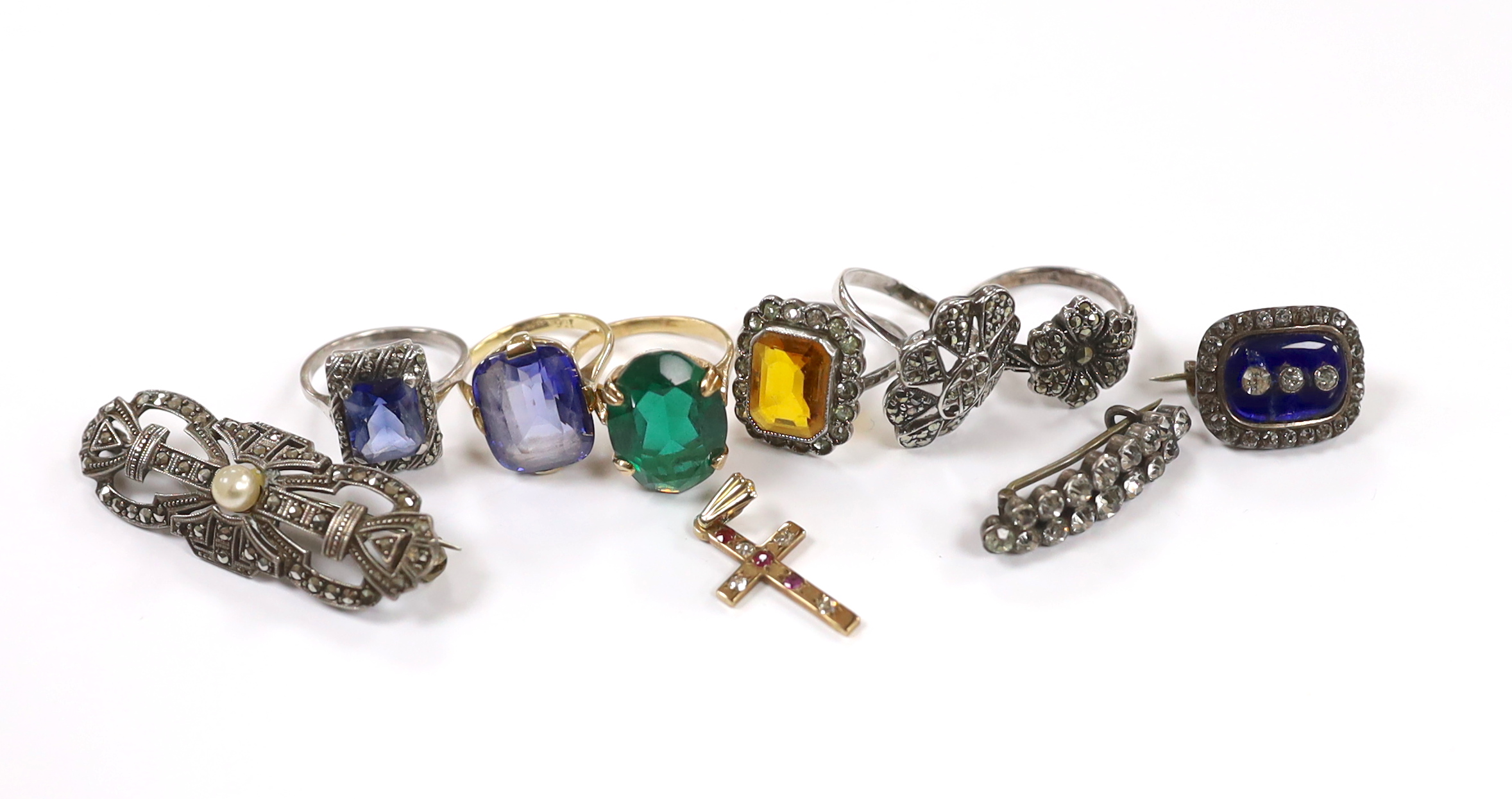 A 9ct and single stone rectangular cushion cut synthetic sapphire set ring, a 9ct gold and gem set cross pendant and a small group of early to mid 20th century jewellery including marcasite and paste set.
